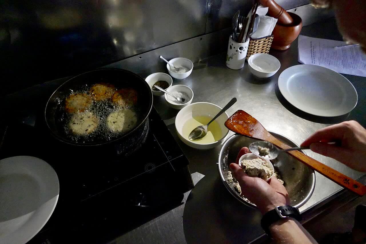 Hands preparing food during a cooking class in Hoi An
