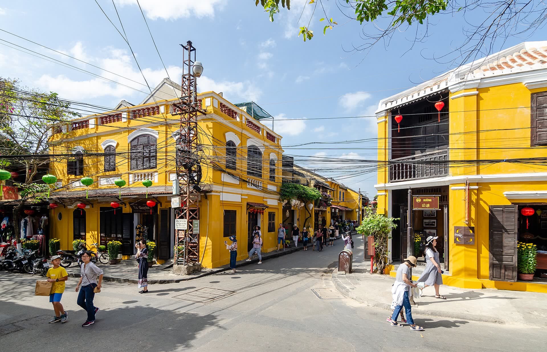 Yellow-washed shophouses and a bicycle on a quiet Old Town street